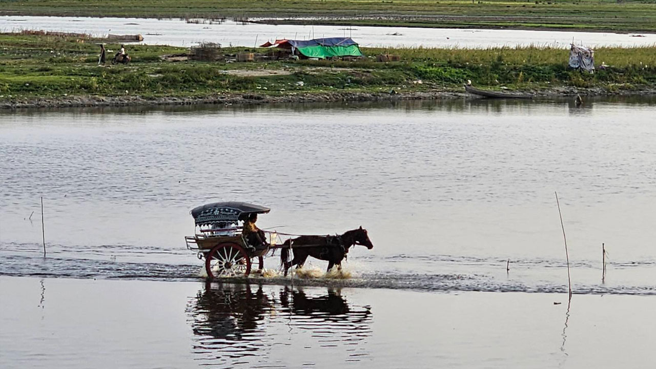 မန္တလေးမြို့၊ အမရပူရမြို့နယ်၊ တောင်သမန်အင်းတွင် မောင်းနှင်နေသည့် မြန်မာ့ရိုးရာမြင်းလှည်းတစ်စီးကို ၂၀၂၃ ခုနှစ်၊ ဇွန်လ ၁၇ ရက်နေ့က တွေ့ရစဉ်။ (Photo: RFA)