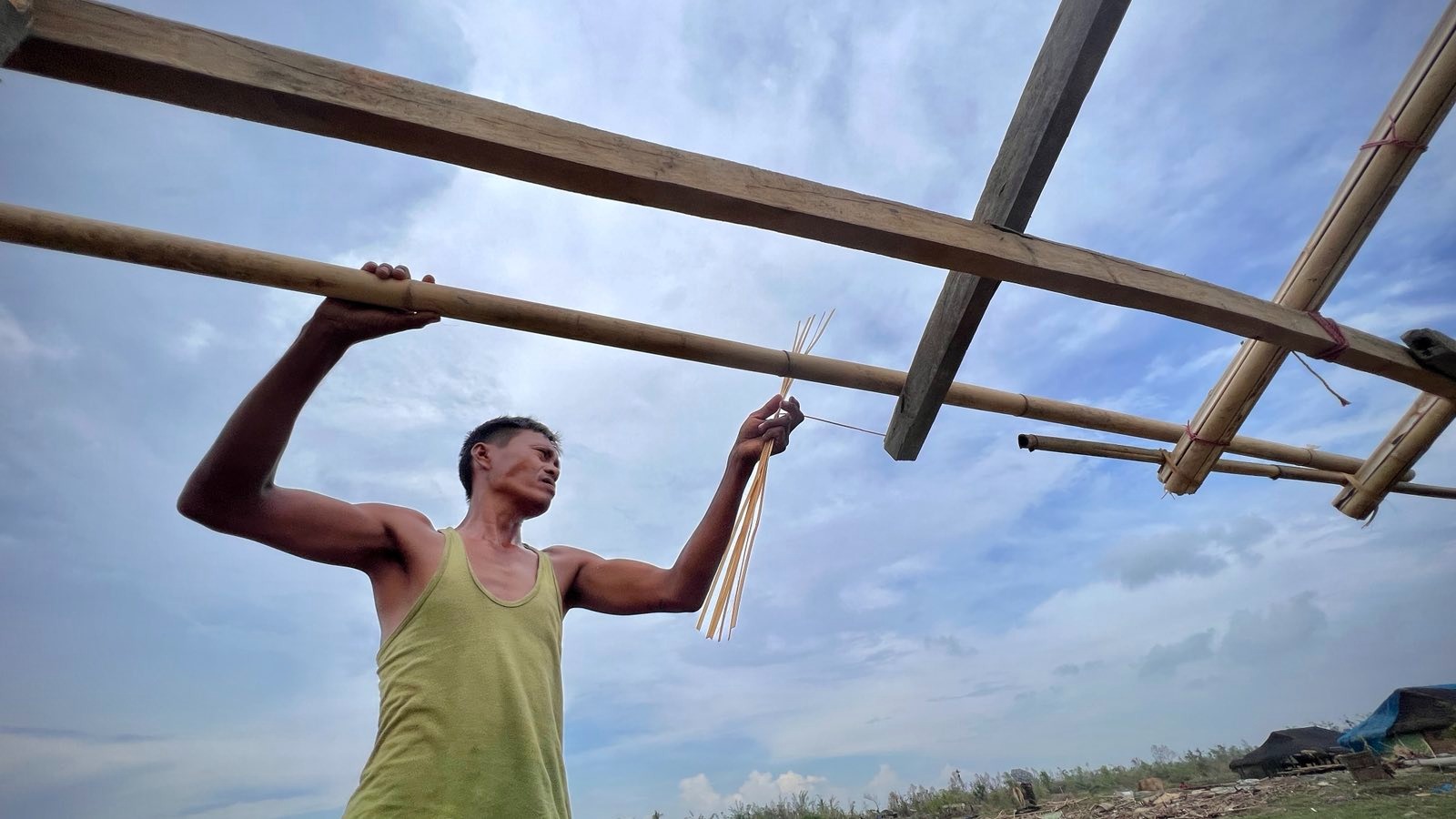ရခိုင်ပြည်နယ်၊ စစ်တွေမြို့နယ်၊ လမ်းဘေးချောင်း ပိုက်ဆိပ် တံငါရွာတွင် နေထိုင်သူတစ်ဦး နေအိမ်ပြန်လည်ပြုပြင်နေသည်ကို ၂၀၂၃ ခုနှစ်၊ ဇွန်လ ၆ ရက်နေ့က တွေ့ရစဉ်။ (Photo: RFA)