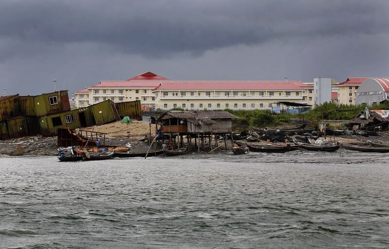 Local fishermen's houses and boats at the foreground of the Chinese oil pipeline project building on Maday island, Kyaukpyu township, Rakhine state, Myanmar Oct. 7, 2015. Credit: Soe Zeya Tun/Reuters