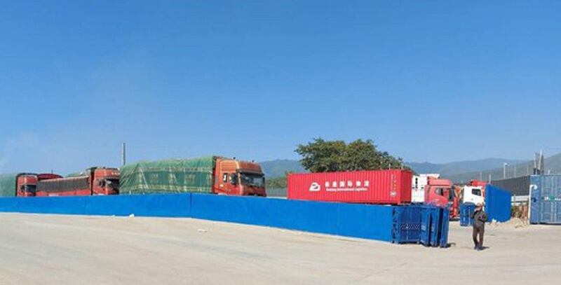 Cargo vehicles arrive at the Kyinsankyawt border gate in Myanmar’s Muse township in Dec. 2021.