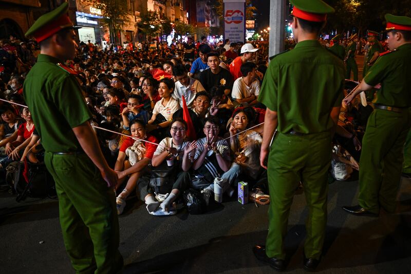 Spectators gather overnight in Ho Chi Minh City in the early hours of on April 30, 2025, ahead of a parade marking the 50th anniversary of the fall of Saigon and the end of the Vietnam War.