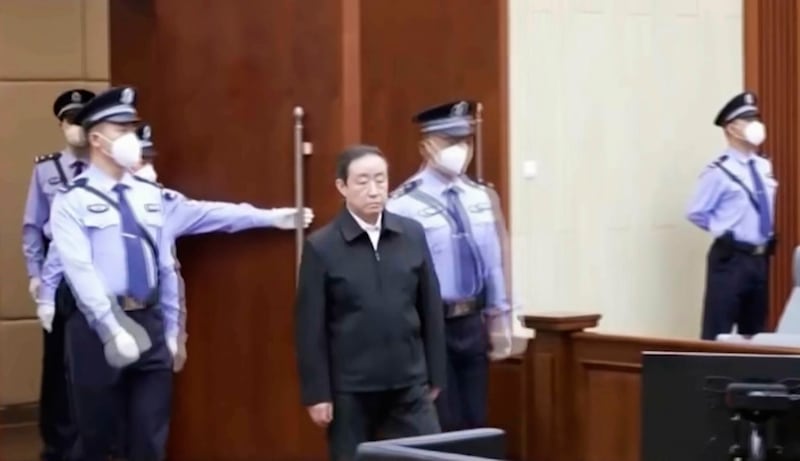 In this image taken from video footage run by China's CCTV, former Chinese justice minister Fu Zhenghua is escorted by court police as he attends a court session for his verdict announcement in Changchun, northeastern China's Jilin province on Thursday, Sept. 22, 2022. Credit: CCTV via AP