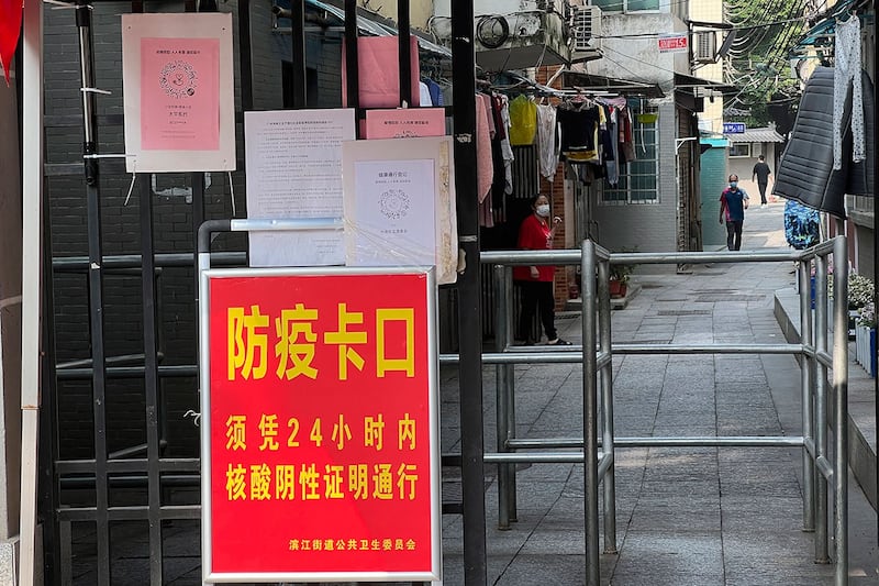 广州市海珠区的一个居民区入口处写着“防疫卡口 须凭24小时内核酸阴性证明通行”。(美联社)