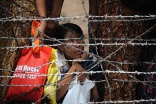 အကျဉ်းသားများ၏ မိသားစုဝင်တဦး မေလ ၁၇ ရက်နေ့က ရန်ကုန်မြို့ အင်းစိန်ထောင်ရှေ့တွင် စောင့်နေပုံ ဖြစ်ပါသည်။ အကျဉ်းသားအားလုံးကို ထောင်ဒဏ်တနှစ်စီ လျှော့ပေါ့ပေးပြီး အင်္ဂါနေ့မှစပြီး အကျဉ်းသား ၁၇ ၀၀၀ ကို စတင် လွှတ်ပေးနေကြောင်း ဦးသိန်စိန် အစိုးရက ကြေငြာခဲ့ပြီး သော်လည်း နိုင်ငံရေး အကျဉ်းသား ၂၀၀၀ ကျော် အကျဉ်းထောင်တွင်း ကျန်ရှိနေသေးသည့်အပေါ် ပြည်တွင်းပြည်ပ အဖွဲအစည်းများက ပြင်းပြင်းထန်ထန် ရှုတ်ချခဲ့ကြသည်။ ဓါတ်ပုံ (AFP)