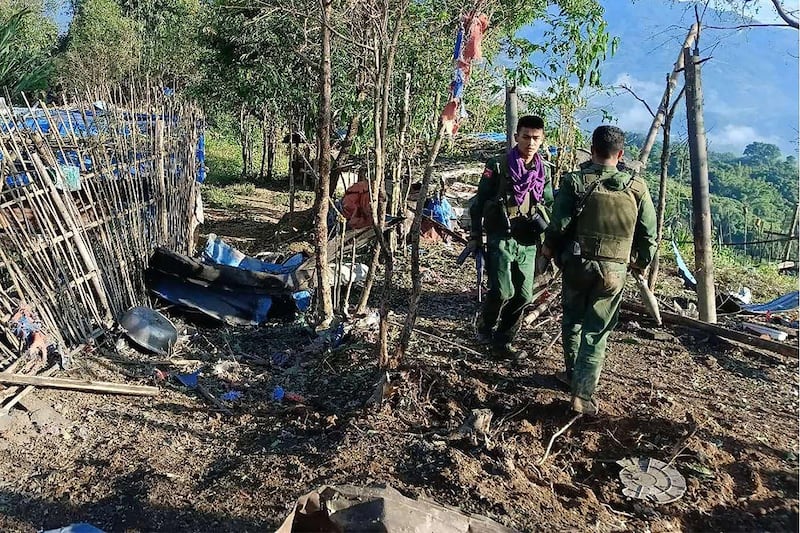 Myanmar National Democratic Alliance Army (MNDAA) fighters walk past a Myanmar military base after seizing it during clashes in Myanmar's northern Shan state, Oct. 28, 2023. (Kokang Information Network via AFP)