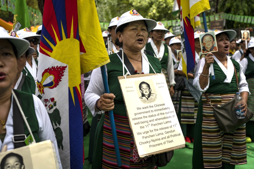 Tibetan Women's Association hold placards and portraits of the 11th Panchen Lama, Gendhun Choekyi Nyima Ap.jpg