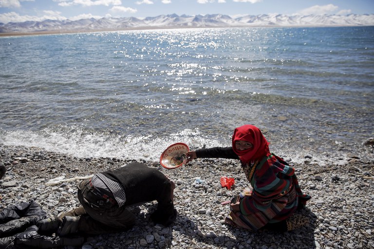 A Tibetan woman helps a man to wash his hair with water from Namtso lake in the Tibet Autonomous Region, China November 18, 2015. Located four hours' drive from Lhasa at an altitude of around 4,718m (15,479 (1).JPG A Tibetan woman helps a man to wash his hair with water from Namtso lake in the Tibet Autonomous Region, China November 18, 2015. Located four hours' drive from Lhasa at an altitude of around 4,718m (15,479 (1).JPG