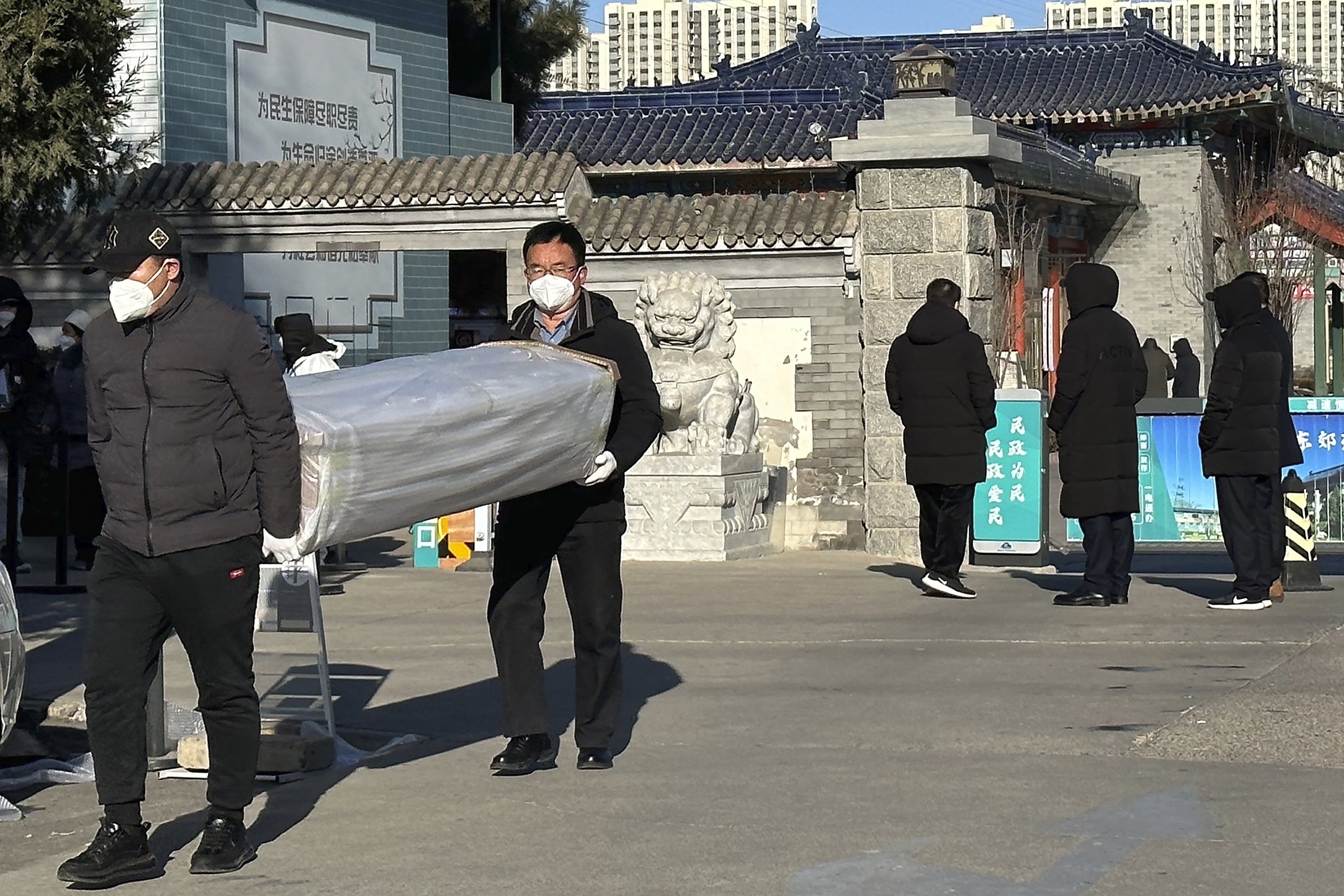 two Beijing men carried coffins outside the crematorium.jpg